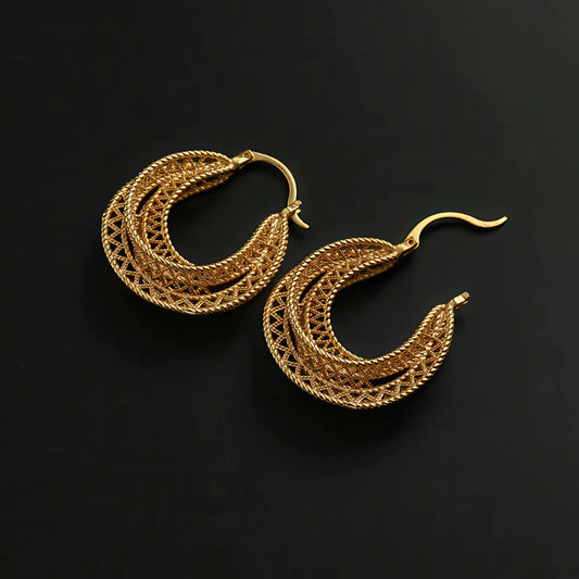 Pair of gold hoop earrings on a black background. #Style_A