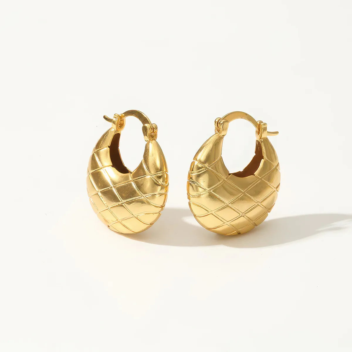 Pair of gold hoop earrings on a white background. #Style_A
