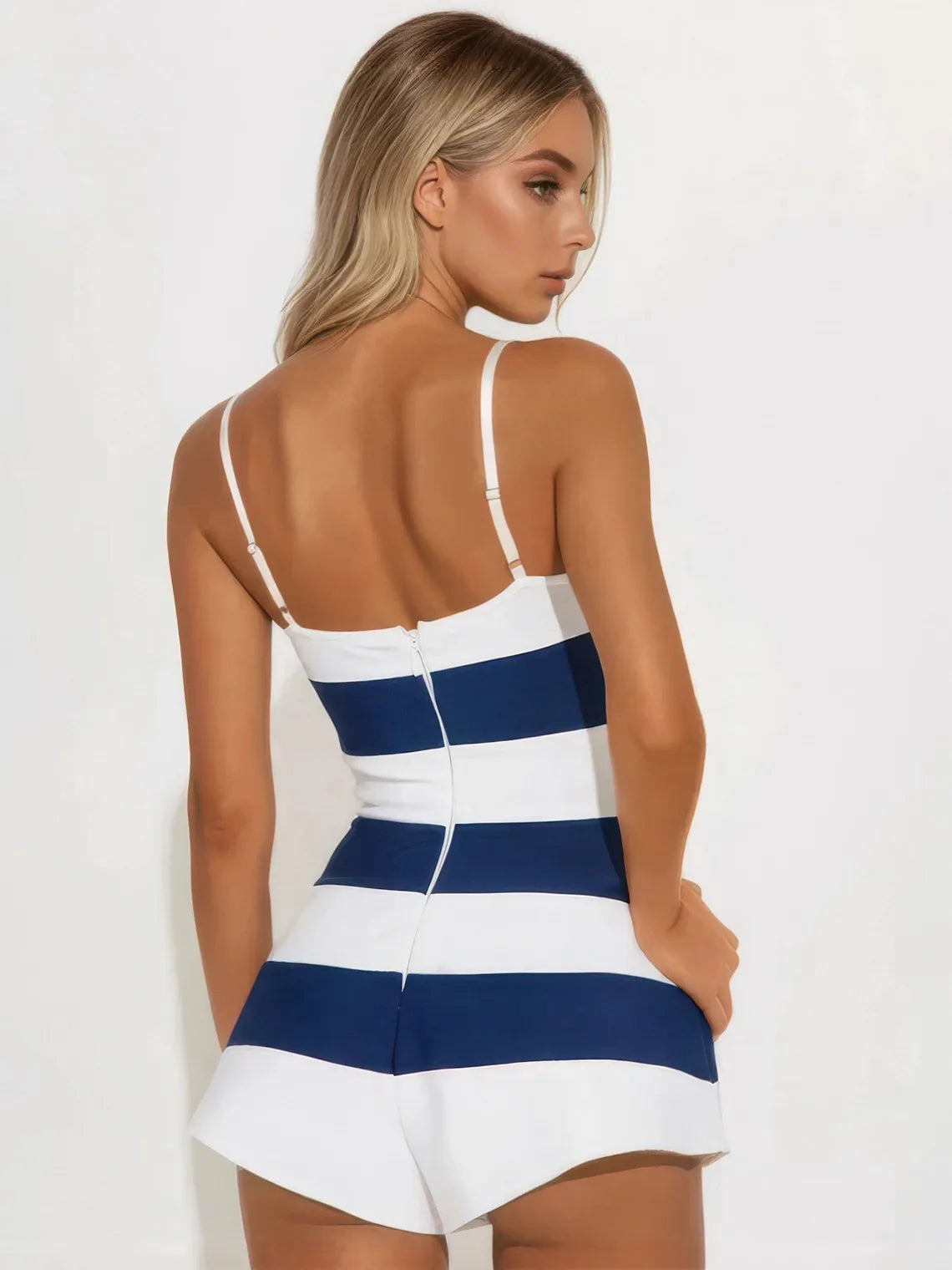 Woman wearing a blue and white striped dress against a plain background | IFAUN