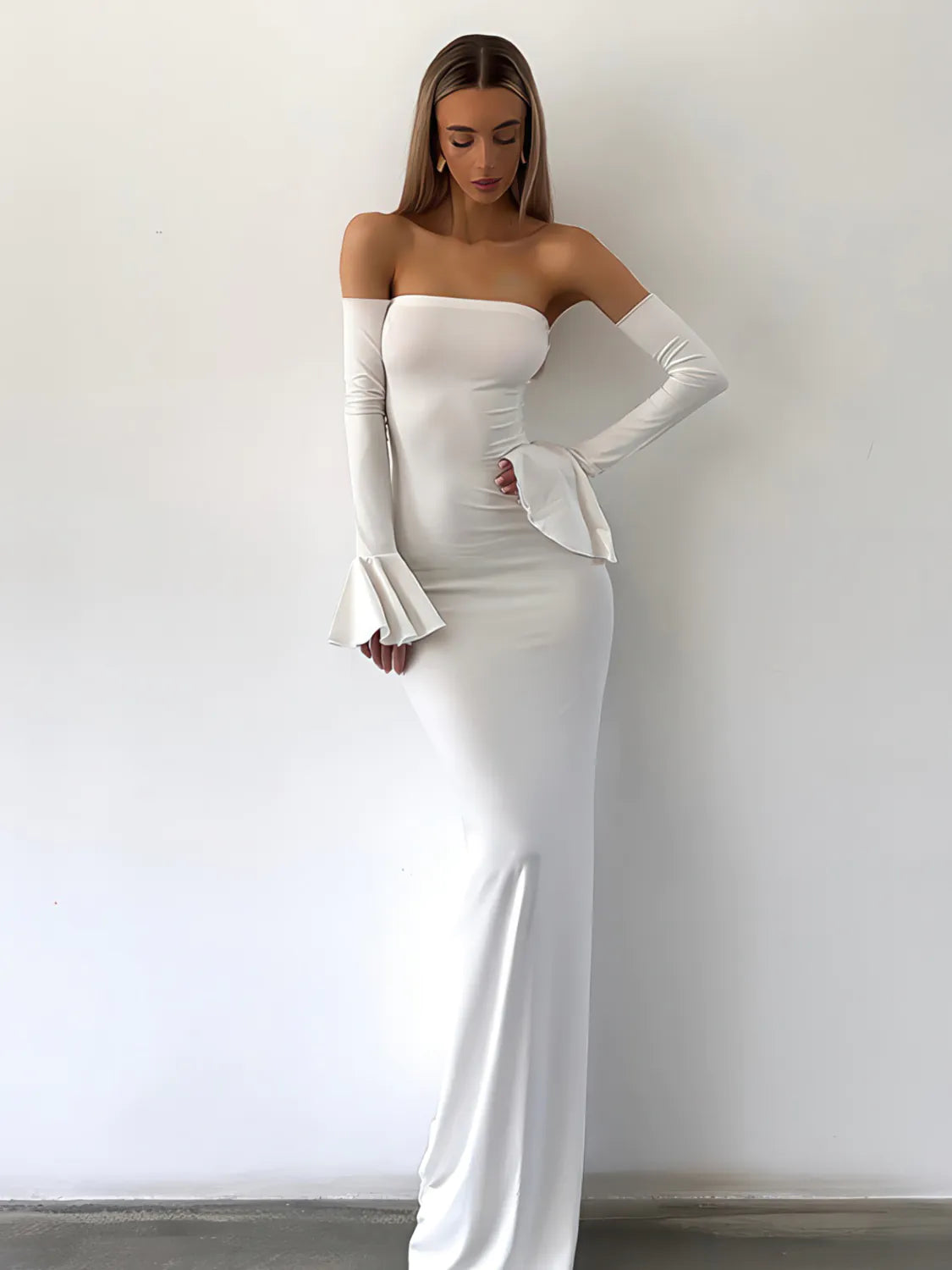 Woman wearing a white strapless gown with long gloves against a plain background. #Color_White