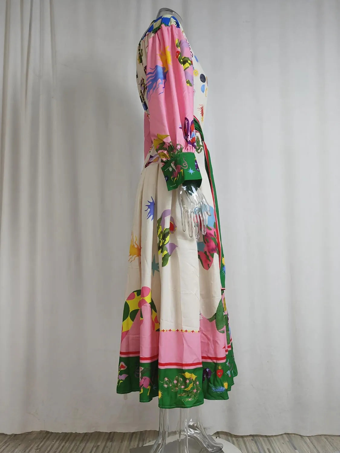Colorful dress with floral patterns on a mannequin against a plain background. #Color_Violet