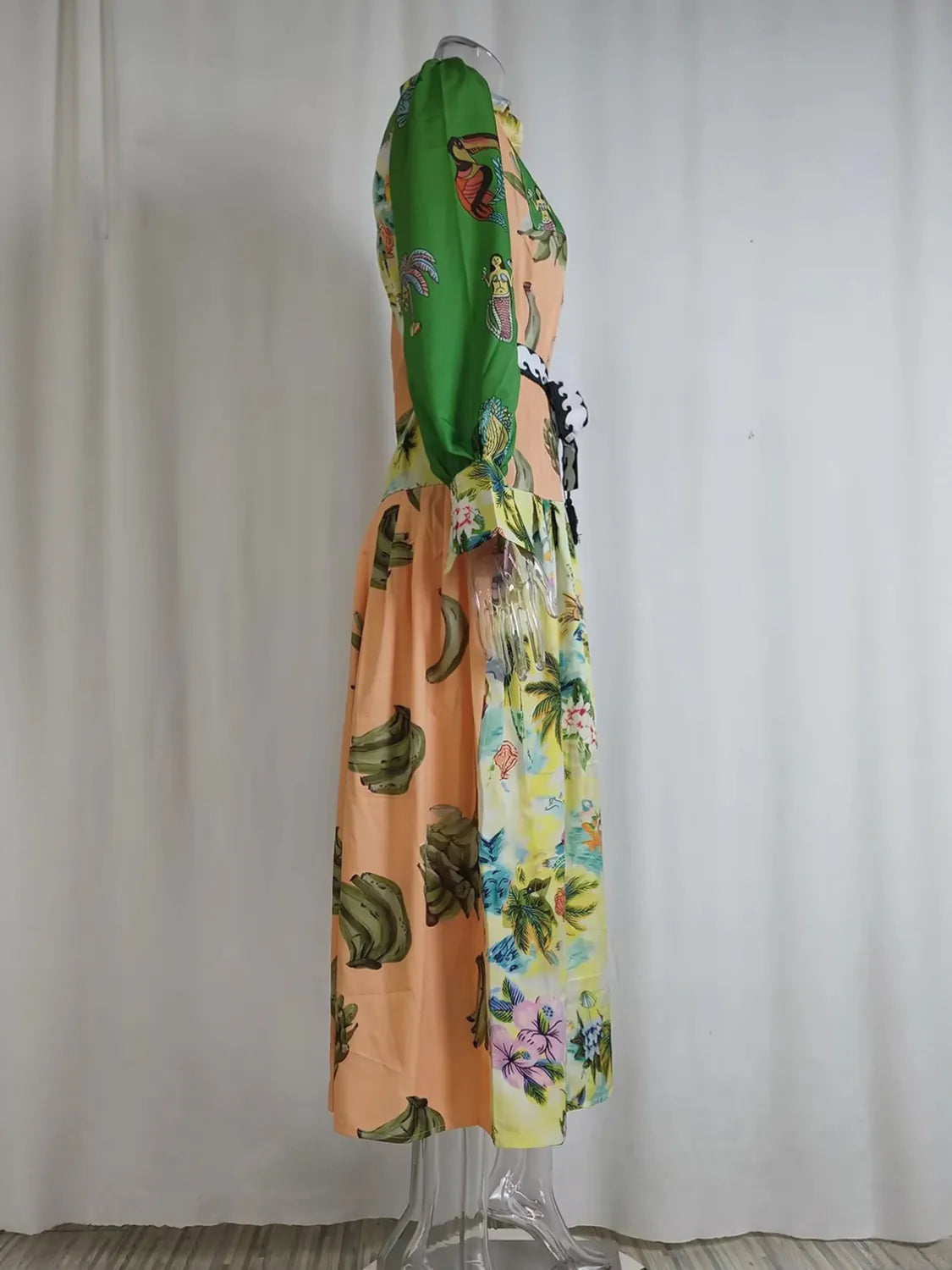 Mannequin wearing a colorful dress with floral and abstract patterns against a plain background. #Color_RosyBrown