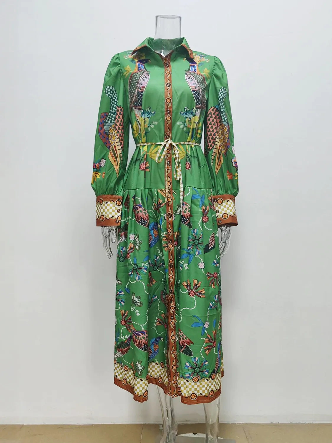 Green dress with colorful pattern on a mannequin against a white background. #Color_Green