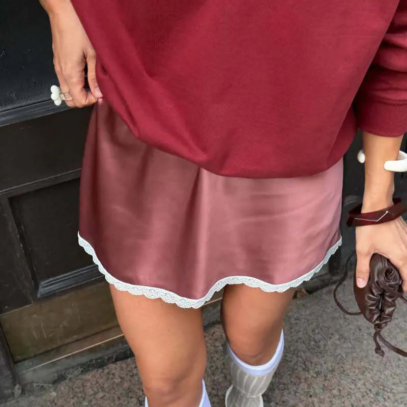 Person wearing a maroon nightgown with lace trim and white socks. #Color_Red