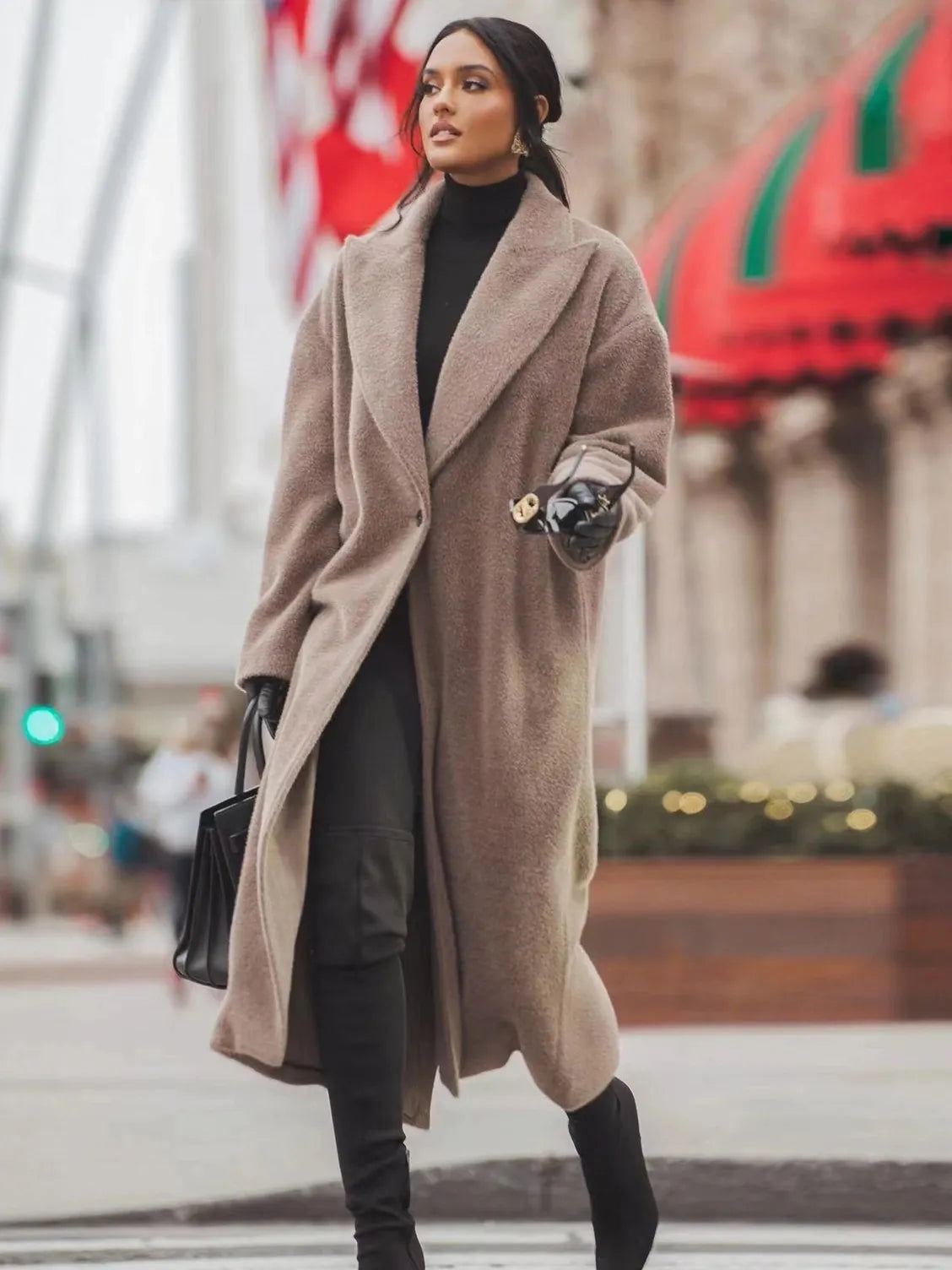 Woman wearing a long beige coat in an urban setting
